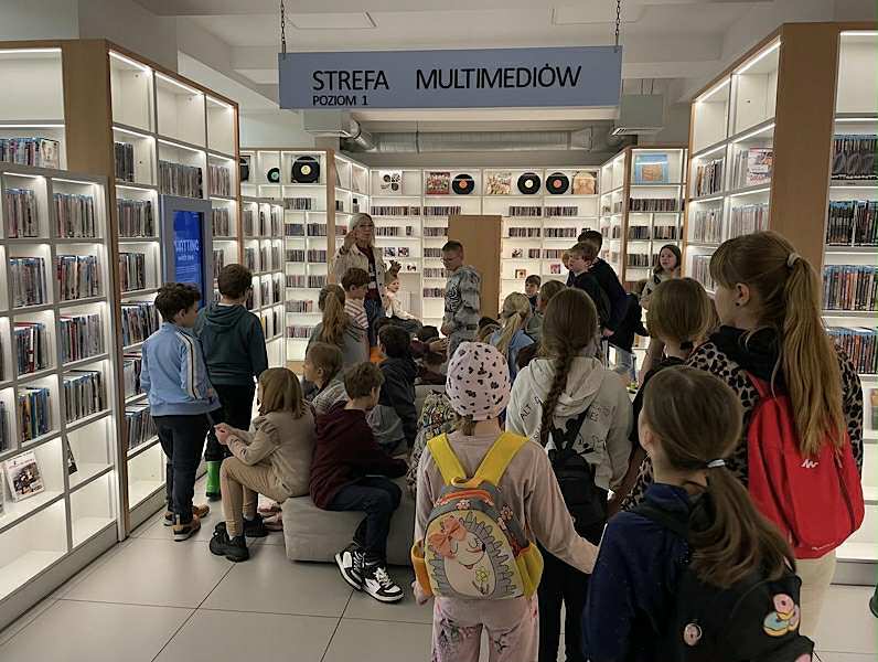 Zdjęcie przedstawia klasy 3a,b,c w sali multimediów w Miejskiej Bibliotece w Żorach.