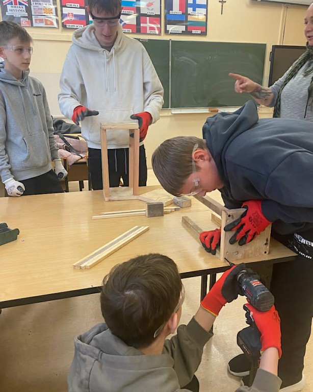 Zdjęcie przedstawia uczniów klasy 8b podczas robienia lampionów świątecznych-grupa 3