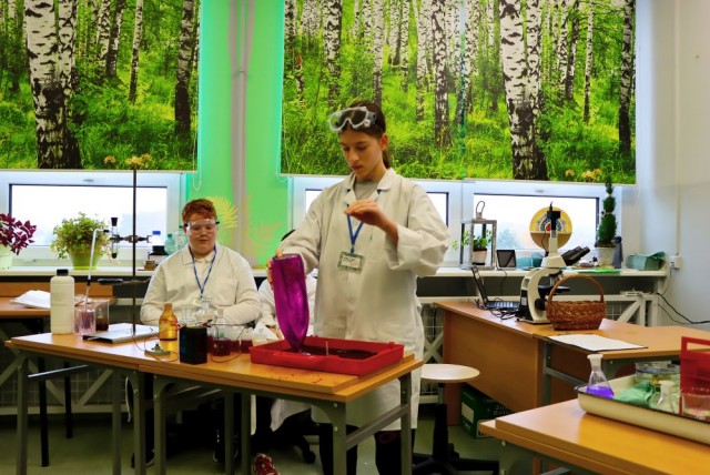 Obraz przedstawia uczniów wykonujących zadania laboratoryjne